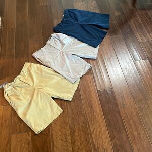 3 pair of boys Under Armour golf shorts size 16. Gray, navy and khaki. Like new.